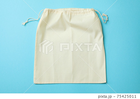 Drawstring eco bag on blue background, space for text Drawstring eco bag on blue background, space for text 75425011