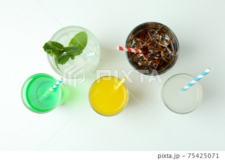 Glasses of different soda on white background Glasses of different soda on white background 75425071