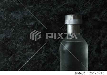 Blank bottle of vodka on black smokey background, space for text Blank bottle of vodka on black smokey background, space for text 75425213