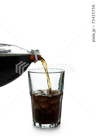 Cola is poured into a glass from bottle, isolated on white background Cola is poured into a glass from bottle, isolated on white background 75425756