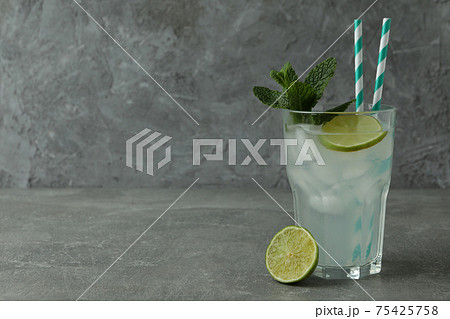 Glass of mojito cocktail on gray table Glass of mojito cocktail on gray table 75425758