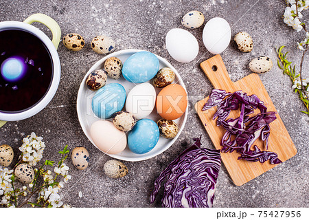 Process of painting Easter eggs in blue 75427956