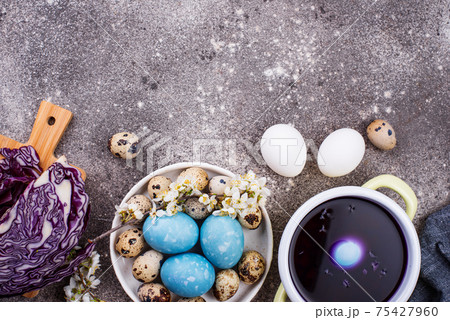 Process of painting Easter eggs in blue Process of painting Easter eggs in blue 75427960