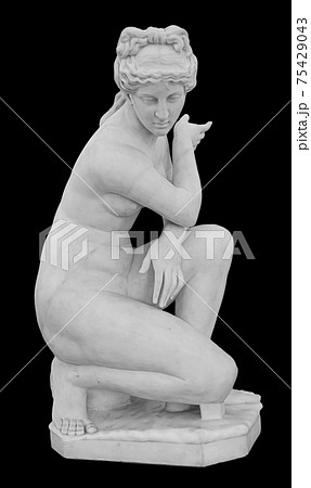 Ancient marble statue of a nude woman. Antique naked female sculpture. Sculpture isolated on black background 75429043