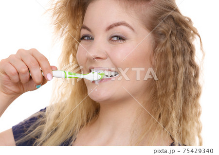 Woman brushing cleaning teeth Woman brushing cleaning teeth 75429340