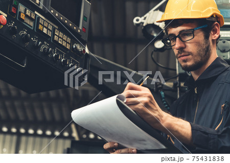 Skillful factory worker working with clipboard to do job procedure checklist . Skillful factory worker working with clipboard to do job procedure checklist . 75431838