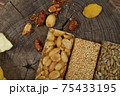 Kozinaki of sesame on the wooden background 75433195
