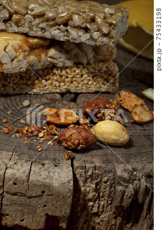Kozinaki of sesame on the wooden background Kozinaki of sesame on the wooden background 75433198