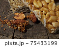 Kozinaki of sesame on the wooden background 75433199