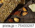 Kozinaki of sesame on the wooden background 75433207