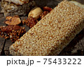 Kozinaki of sesame on the wooden background 75433222
