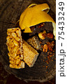 Kozinaki of sesame on the wooden background 75433249