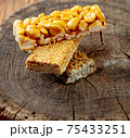 Kozinaki of sesame on the wooden background 75433251