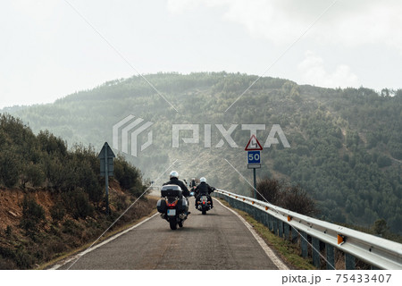 Motorbikers on Mountain Road. Driving a empty road Motorbikers on Mountain Road. Driving a empty road 75433407