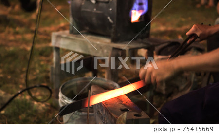Blacksmith making hitting sword handmade traditional craftmanship show Blacksmith making hitting sword handmade traditional craftmanship show 75435669