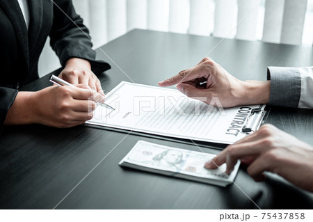Businessman giving bribe money to businesswoman to bribing deal contract in a corruption, Illegal, dishonest and scam Businessman giving bribe money to businesswoman to bribing deal contract in a corruption, Illegal, dishonest and scam 75437858