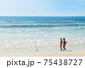 Tourist people walk along Thai Kata Noi beach in Phuket, calm sunny idyllic beach landscape 75438727