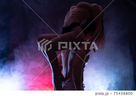 silhouette of a loving couple in a close embrace of passion and attraction. Concept of temptation, togetherness and seduction silhouette of a loving couple in a close embrace of passion and attraction. Concept of temptation, togetherness and seduction 75438800