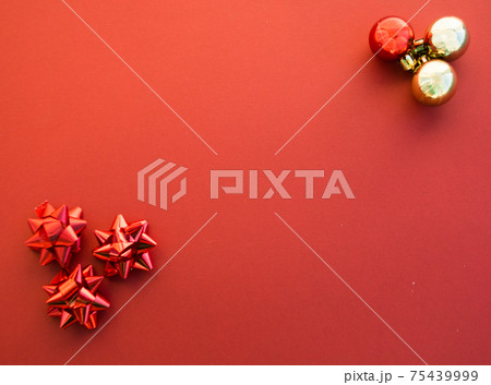 Gold and red Christmas tree balls on red paper background. Minimal Christmas concept 75439999