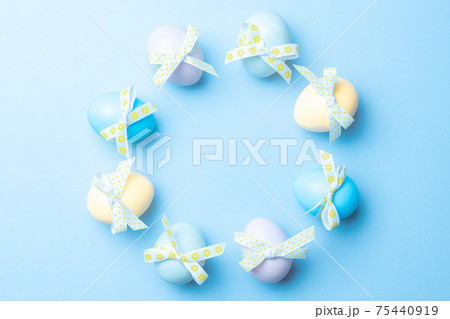 Easter message. Colourful egg with tape ribbon on pastel blue background in Happy Easter decoration. Foil minimalist egg design, modern top view template. Easter message. Colourful egg with tape ribbon on pastel blue background in Happy Easter decoration. Foil minimalist egg design, modern top view template. 75440919