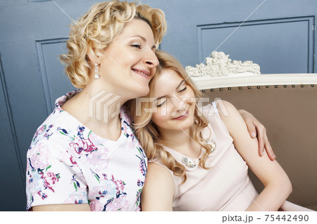 lifestyle people concept: mature blond mother with teenage daughter at home together lifestyle people concept: mature blond mother with teenage daughter at home together 75442490