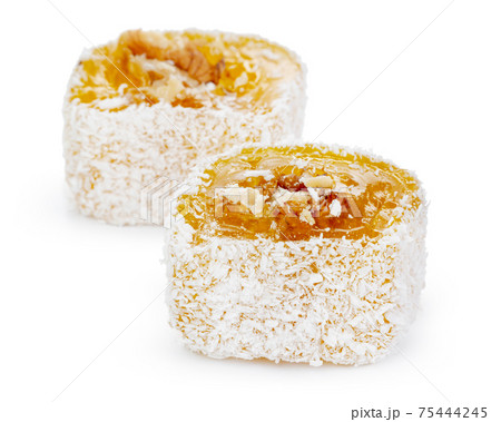 Yellow Turkish Delight with nuts in powdered sugar isolated on white 75444245
