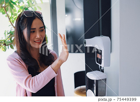 Healthy lifestyle of young woman use the palm of hand to measure the temperature with thermometer Healthy lifestyle of young woman use the palm of hand to measure the temperature with thermometer 75449399
