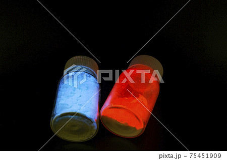 Luminescent organic materials in the form of a powder inside a two glass bottles. Luminescent organic materials in the form of a powder inside a two glass bottles. 75451909