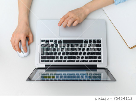 Workspace with hands typing on laptop. Flat lay, top view 75454112