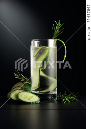 Cold detox drink with ice, cucumber, and rosemary. 75457647
