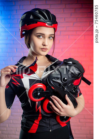 cute woman in sportswear and helmet with roller skates cute woman in sportswear and helmet with roller skates 75460785