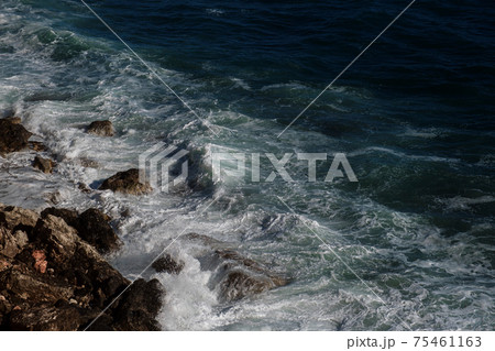 Ocean wave background breaking sea water rocky shore 75461163
