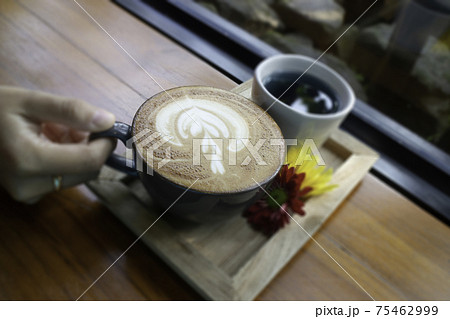 Latte coffee art cup in the garden Latte coffee art cup in the garden 75462999