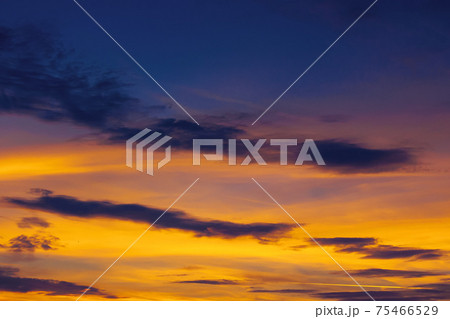 dark clouds on the glowing sky at sunset. dramatic nature scenery on the windy weather in evening dark clouds on the glowing sky at sunset. dramatic nature scenery on the windy weather in evening 75466529