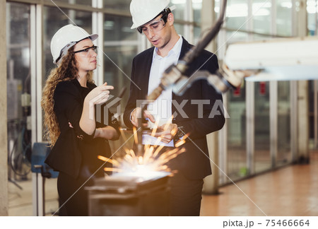 Engineer with digital tablet supervising autonomous producton process 75466664