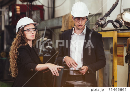 Engineer with digital tablet supervising autonomous producton process 75466665