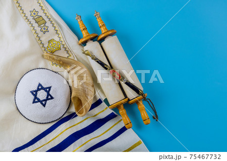 Jewish holidays, during prayer items kippa with prayer shawl tallit on shofar, torah scroll 75467732