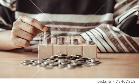 Woman's hands put the coins arranged in steps, Managing your finances or saving money for future use, Saving for investment, Saving money for business growth or long-term profitability. 75467818