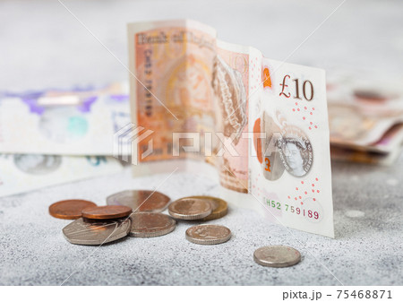 Ten pounds banknote with coins and other money on light background. Economy crisis concept. 75468871
