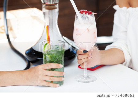 Two cocktails close up in a cafe on the street 75469663