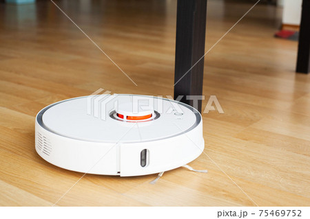 Robot vacuum cleaner performs automatic cleaning of the apartment at a certain time. Smart home. 75469752