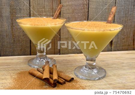 Boza and cinnamon sticks, traditional Turkish cuisine drinks, on wooden background 75470692