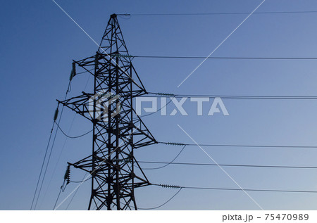 Top part of high voltage post. High-voltage tower sky background. Space for text Top part of high voltage post. High-voltage tower sky background. Space for text 75470989