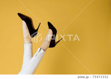 Inverted female legs black shoes attractive look yellow background shopping Inverted female legs black shoes attractive look yellow background shopping 75471552