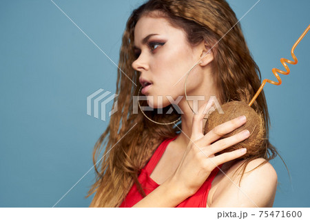 woman with coconut cocktail in hands wavy hair bright makeup lifestyle studio summer vacation woman with coconut cocktail in hands wavy hair bright makeup lifestyle studio summer vacation 75471600