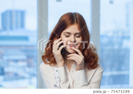 woman manager in office talking on the phone 75473299