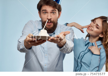 Party man and woman birthday cake corporate fun blue background 75473577