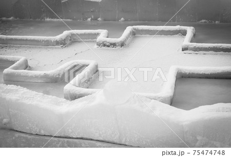 Font for dipping into an ice hole for the baptism of christ and ice sculpture in the form of an angel and a cross 75474748