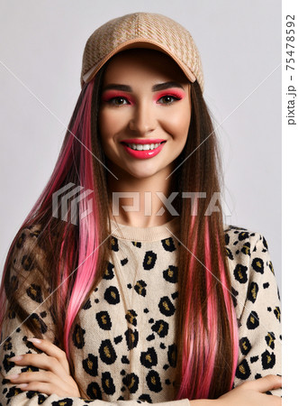 Portrait of friendly smiling young woman with pink 75478592