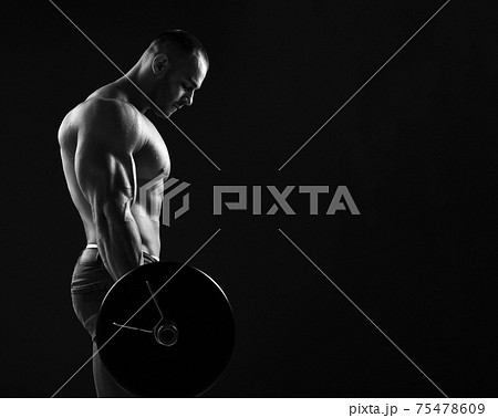 Strong men athlete, weightlifter does exercises Strong men athlete, weightlifter does exercises 75478609